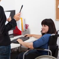 Disabled woman in wheelchair at work