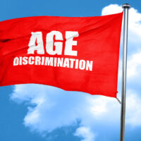 red waving flag with age discrimination caption on it red waving flag with age discrimination caption on it