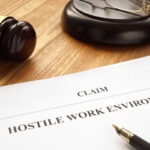 hostile work environment claim form next to gavel in court