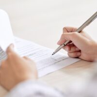 Crop person signing contract Crop person signing contract