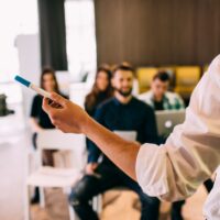 Lecture and training in business office for white collar colleagues. Focus on hands of speaker. Lecture and training in business office for white collar colleagues. Focus on hands of speaker.