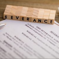 Severance Pay concept with agreement document on wooden board Severance Pay concept with agreement document on wooden board
